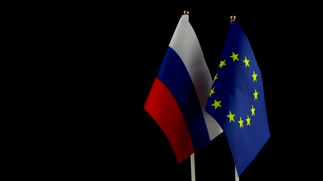 EU and Russia flags on black background. Sanctions pressure, politics concept photo. Europe union vs Russia. Copy space photo