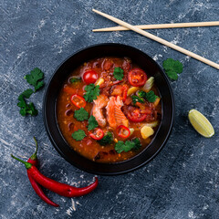 Delicious homemade fish and seafood soup with vegetables and tomatoes. Served in a round bowl.