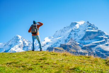 Tourist with a backpack in the mountains. Mountain hiking in the high mountains. Travel and...