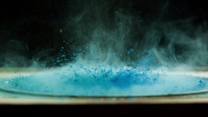 Subwoofer with blue paint powder. Loud music volume macro shooting. Professional disco studio equipment. Playback of musical stereo system, vibration, acoustic sound system.