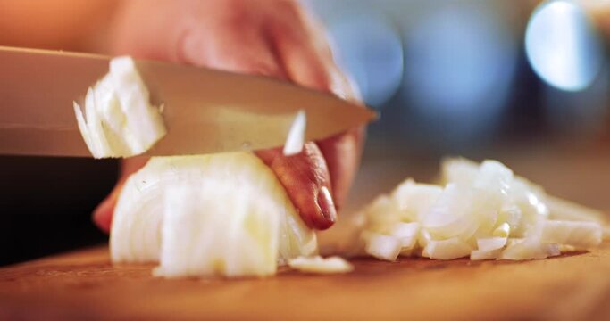 Preparing traditional food, chopping or slicing onion using a knife, slow motion