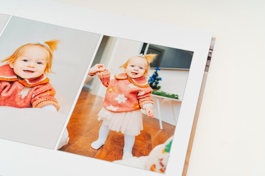 a Photobook of family at home on white background. page with baby girl