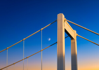 The bridge against the sunset sky. Urban architecture and sky gradient during sunset. Photography for background and design.