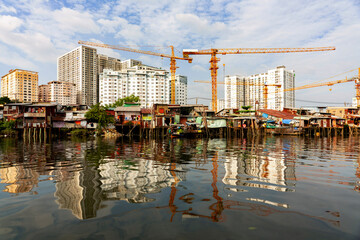 Poor houses in front of new skyscrapers at Mekong in Ho-Chi-Minh-City