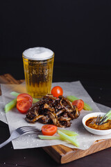 Selective focus on fried ear of pork with tomatoes celery and sauce sprinkled with sesame seeds