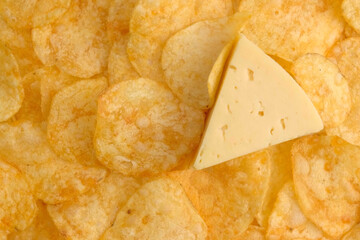 Background of Potato chips and slice of a cheese close up. Nutrition concept. Top view, copy space. 