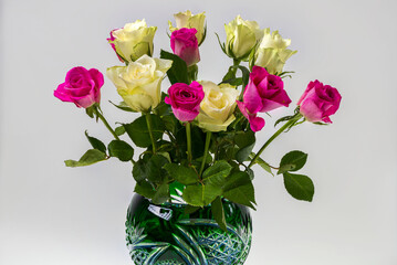 Close up view of beautiful white and pink roses in crystal vase.