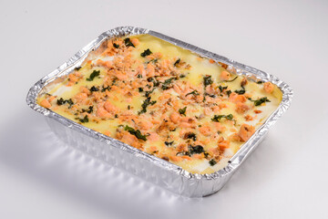 Lasagna delivery. Salmon lasagna in packaging for delivery isolated on white background.