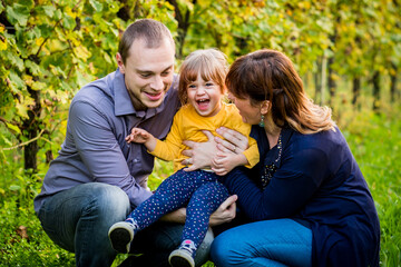 Fototapeta premium Portrait of happy family having fun together at a vineyard at sunny day