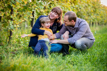 Portrait of happy family having fun together at a vineyard at sunny day