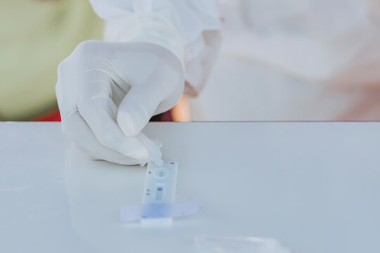 Medical professional doing a COVID antigen test