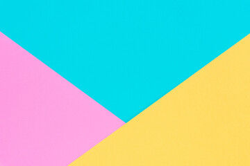 Yellow, pink and blue colored paper. Geometric empty paper background of three tones for copy space