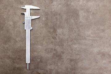 Another side of the opened metal caliper on the rusty grunge background with copy space