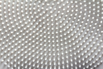 Close up texture of gray colored dotted rubber surface texture.