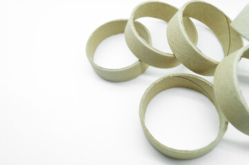 Narrow cardboard spools for winding rolled materials and self-adhesive labels. Reels made of cardboard for printing houses. Selective focus, isolated on white