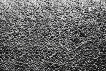 Close up photo of frozen concrete surface covered in ice texture background.