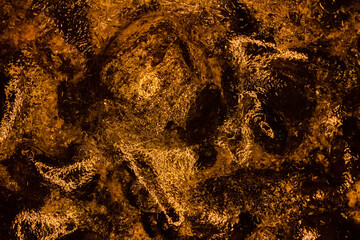 Photo of orange toned frozen wooden coal covered in ice surface texture.