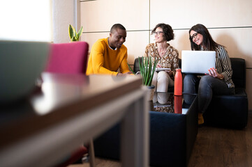 Working group preparing a project with a laptop in an office.