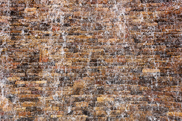 Stone Wall with Water Falling Down the Surface