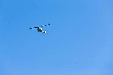 a flying helicopter of us air force in the blue clear sky in tokyo