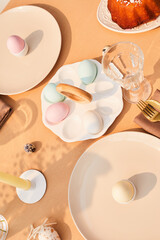 Top view background of elegant dinner table decorated for easter in sunlight, copy space