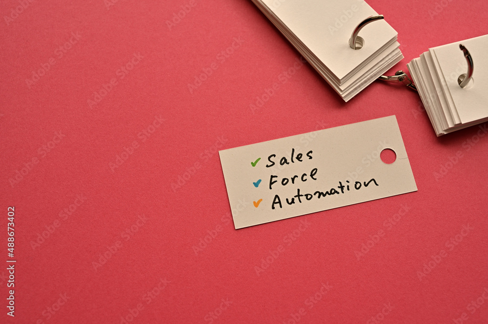Poster there is a small card placed on a red background paper with the word sales force automation written 