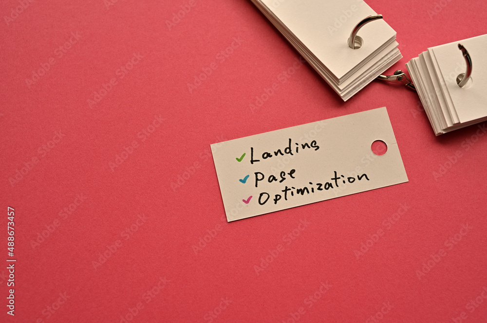 Poster there is a small card placed on a red background paper with the word landing page optimization writt