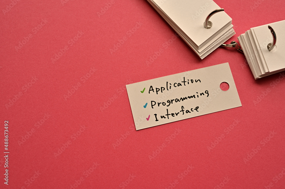 Poster there is a small card placed on a red background paper with the word application programming interfa