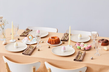 Minimal background image of elegant dinner table decorated for Easter and Spring, copy space