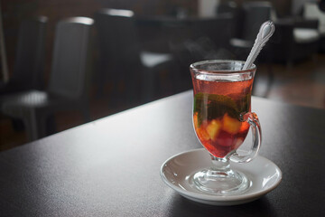 Fruit tea glass cup on the table.Coffee shop. Blurred background. Cold day. Relax. Vertical. Horizontal