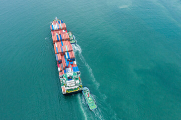 Aerial top view of cargo ship carrying container for import export goods send to customer from...
