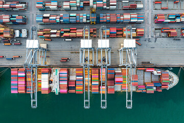 Aerial view Container ships at industrial ports in the business of import, export, logistics and international maritime transport, loading of containers on cargo ships with cranes