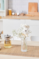 Vertical background of cozy kitchen interior with white table and cute accent details, copy space
