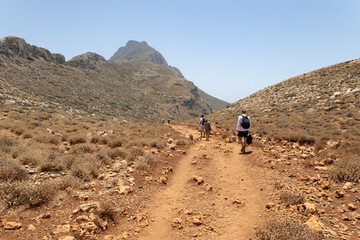 Tourists on the their way toward Balos lagoon, after driving a bumpy unpaved road, on Crete, Greece