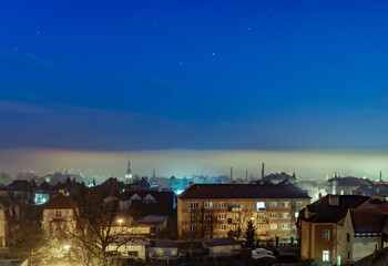 Fototapeta na wymiar fog over the city at dawn.bright stars over glowing mist