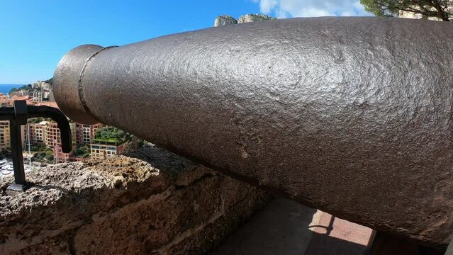 DOLLY SHOT - Old cannon at the Prince's Palace of Monaco. Monaco is a sovereign city-state and microstate, located on the French Riviera in Western Europe. Cannon aiming at the sea. 