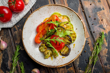 grilled vegetables on a plate on old wooden table top view