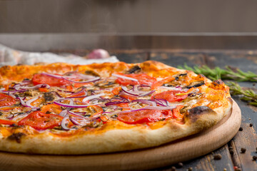 Pizza with vegetables and cheese, vegetarian pizza with steam on old wooden table macro close up