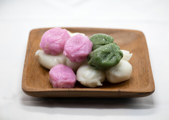 Korean food five colors honey rice cake served on a wooden plate on a white background