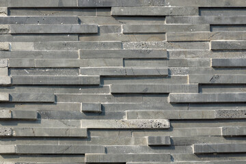 Red and dark gray bricks installed on the wall of the house