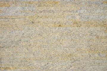 Mustard-colored marble installed on the wall of the house