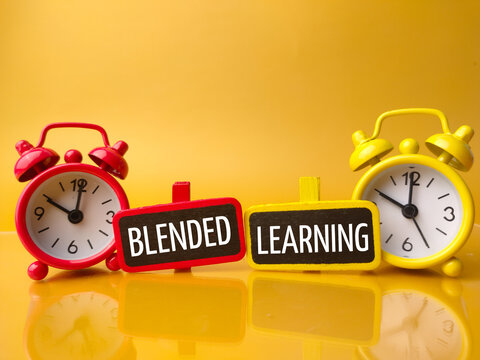 Clock and colored board with text BLENDED LEARNING on a yellow background.