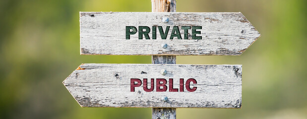 opposite signs on wooden signpost with the text quote private public engraved. Web banner format. - obrazy, fototapety, plakaty