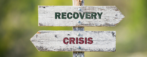 opposite signs on wooden signpost with the text quote recovery crisis engraved. Web banner format.