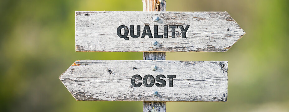 opposite signs on wooden signpost with the text quote quality cost engraved. Web banner format.