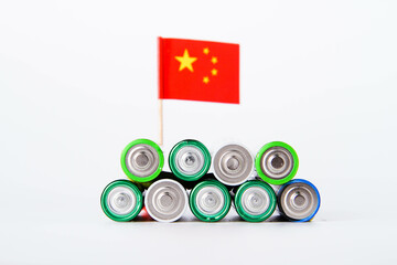 Battery. A lot of batteries on the background of the flag of the country.