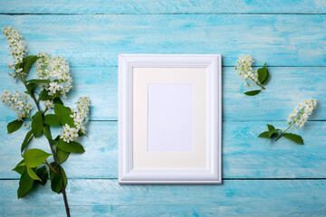 White small frame mockup with bird cherry on the blue