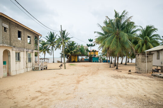 Sand path to local beach bar at Caribbean ocean in Hopkins, Belize
