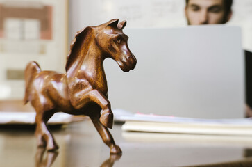 wooden horse sculpture on a desk