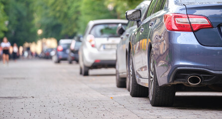 Naklejka premium Close up of a car parked illegally against traffic rules on pedestrian city street side